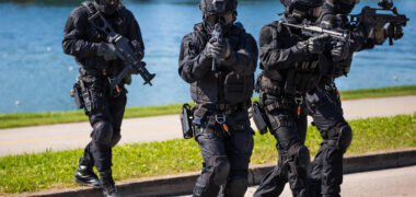 Special forces tactical team of four in action, unmarked and unrecognizable swat team