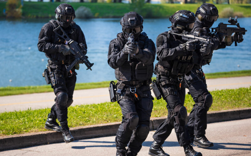 Special forces tactical team of four in action, unmarked and unrecognizable swat team